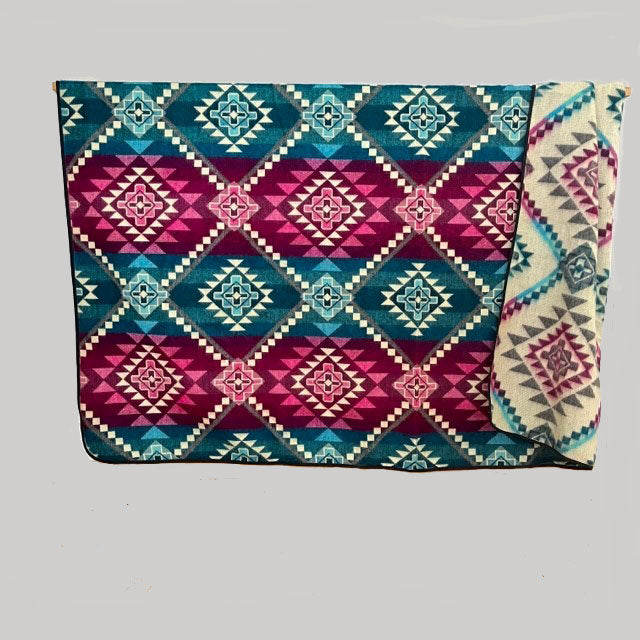 Chevere Antizana-Decke in pink und türkis. Ansicht von Vorder- und Rückseite mit pink-türkisen Ethno-Muster.